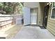 Back patio features a concrete slab with privacy fence, and doorway access to the unit at 1406 Bayrose Cir # 6B, East Point, GA 30344