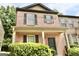 Picturesque two-story brick townhome with a covered front porch and lush green landscaping at 1406 Bayrose Cir # 6B, East Point, GA 30344
