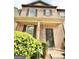 Classic two-story brick townhome with a charming covered porch and front yard shrubs at 1406 Bayrose Cir # 6B, East Point, GA 30344