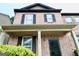 Attractive two-story brick townhome with dark shutters and lush green landscaping at 1406 Bayrose Cir # 6B, East Point, GA 30344