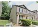 Comfortable two-story brick townhome featuring a covered front porch and trimmed shrubs at 1406 Bayrose Cir # 6B, East Point, GA 30344