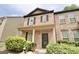 Lovely two-story brick townhome featuring a covered front porch and well-kept greenery at 1406 Bayrose Cir # 6B, East Point, GA 30344