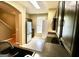 Well-lit kitchen featuring stainless steel appliances, dark wood cabinets, and a view of the open staircase at 1406 Bayrose Cir # 6B, East Point, GA 30344