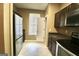 Clean kitchen showcases stainless steel refrigerator and appliances, cabinets and tiled floor in neutral tones at 1406 Bayrose Cir # 6B, East Point, GA 30344