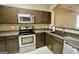 Modern kitchen featuring stainless steel appliances, dark cabinets, and durable countertops, perfect for culinary adventures at 1406 Bayrose Cir # 6B, East Point, GA 30344