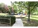 Community playground with a mulched surface, several play structures and mature shade trees at 1406 Bayrose Cir # 6B, East Point, GA 30344
