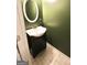Charming powder room with stylish vanity, lighting and a round decorative mirror at 1406 Bayrose Cir # 6B, East Point, GA 30344