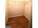 Empty walk-in closet with vinyl floor and wire shelving for clothing and personal items at 1406 Bayrose Cir # 6B, East Point, GA 30344