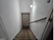 Carpeted staircase with handrail leading to the lower level, illuminated by a wall-mounted light fixture at 270 Huntington St, Covington, GA 30016