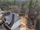 Aerial view of the house with a new roof and detached garage in a wooded setting at 123 Stratmore Pl, Stockbridge, GA 30281
