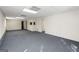 Spacious carpeted basement with neutral color walls, drop ceilings, white doors, and electrical outlets at 123 Stratmore Pl, Stockbridge, GA 30281