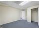 Spacious carpeted basement with neutral color walls, drop ceilings, white doors, and electrical outlets at 123 Stratmore Pl, Stockbridge, GA 30281