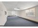 Spacious carpeted basement with neutral color walls, drop ceilings, white doors, and windows at 123 Stratmore Pl, Stockbridge, GA 30281