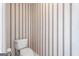 Bathroom featuring a toilet and decorative wallpaper at 123 Stratmore Pl, Stockbridge, GA 30281