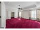 Spacious bedroom featuring red carpet, tray ceiling and white trim at 123 Stratmore Pl, Stockbridge, GA 30281