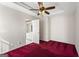 Bedroom featuring a ceiling fan, tray ceiling, and door to bathroom at 123 Stratmore Pl, Stockbridge, GA 30281