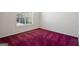 This bedroom features a window for natural light and vibrant carpet at 123 Stratmore Pl, Stockbridge, GA 30281