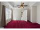 Bedroom featuring a ceiling fan, tray ceiling, and large windows at 123 Stratmore Pl, Stockbridge, GA 30281