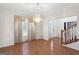 Formal dining room with hardwood floors, a chandelier, and large windows at 123 Stratmore Pl, Stockbridge, GA 30281