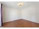Versatile empty room featuring beautiful hardwood floors and neutral paint at 123 Stratmore Pl, Stockbridge, GA 30281