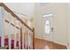Bright foyer with hardwood floors, staircase, and decorative front door at 123 Stratmore Pl, Stockbridge, GA 30281