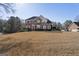 Spacious front yard featuring a brick home with manicured landscaping and mature trees at 123 Stratmore Pl, Stockbridge, GA 30281