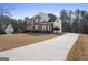Two-story home with a long driveway and landscaped front yard at 123 Stratmore Pl, Stockbridge, GA 30281