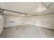 Spacious, unfinished single-car garage features a concrete floor, lighting, and a garage door opener at 123 Stratmore Pl, Stockbridge, GA 30281