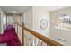 View of the second floor hallway with a large window, chandelier, and view of the home's exterior at 123 Stratmore Pl, Stockbridge, GA 30281
