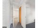 View of hallway with carpet, white brick wall and louvered door in this home at 123 Stratmore Pl, Stockbridge, GA 30281