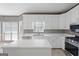 Kitchen featuring white cabinets, stainless steel appliances, and a kitchen island at 123 Stratmore Pl, Stockbridge, GA 30281