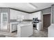 Kitchen featuring white cabinets, stainless steel appliances, and a kitchen island at 123 Stratmore Pl, Stockbridge, GA 30281
