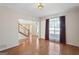 Sunlit living room with hardwood floors, staircase, and large windows at 123 Stratmore Pl, Stockbridge, GA 30281