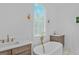 Bright bathroom features a soaking tub, double vanities, and gold accents at 930 Laurel Brooke Ave, Peachtree City, GA 30269
