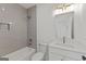 Stylish bathroom featuring grey tile in the shower, a modern vanity, and sleek fixtures at 930 Laurel Brooke Ave, Peachtree City, GA 30269