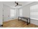 Bright bedroom features hardwood floors, ceiling fan, and modern black desk at 930 Laurel Brooke Ave, Peachtree City, GA 30269