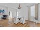 Bright dining room with a modern chandelier, glass-top table, and white slip-covered chairs at 930 Laurel Brooke Ave, Peachtree City, GA 30269