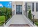 A large, inviting front porch with a black front door at 930 Laurel Brooke Ave, Peachtree City, GA 30269