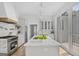 Modern kitchen with stainless steel appliances, a center island, and sliding glass doors to the outside at 930 Laurel Brooke Ave, Peachtree City, GA 30269