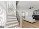 Open-concept living room features hardwood floors, lots of natural light, and a staircase at 930 Laurel Brooke Ave, Peachtree City, GA 30269