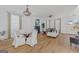 Open living space with dining area, fireplace, hardwood floors, and lots of natural light at 930 Laurel Brooke Ave, Peachtree City, GA 30269