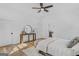 Sun-drenched bedroom boasts hardwood floors, large windows, neutral decor, and modern lighting fixtures at 930 Laurel Brooke Ave, Peachtree City, GA 30269