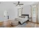 Bright bedroom with wood floors, large windows, ceiling fan and an ensuite bathroom with a soaking tub at 930 Laurel Brooke Ave, Peachtree City, GA 30269