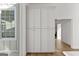 A bright pantry with white paneled doors and silver knobs, offering ample storage solutions and a clean aesthetic at 930 Laurel Brooke Ave, Peachtree City, GA 30269