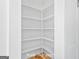 A walk-in pantry features numerous white shelves for ample storage and organizational solutions at 930 Laurel Brooke Ave, Peachtree City, GA 30269