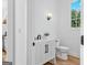 Charming powder room featuring a modern vanity with herringbone design and a convenient toilet at 930 Laurel Brooke Ave, Peachtree City, GA 30269