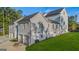 A gray home with a white brick foundation and three garage bays at 930 Laurel Brooke Ave, Peachtree City, GA 30269