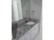 Modern bathroom vanity featuring granite countertop, white cabinetry, and large mirror at 4111 Pine Heights Ne Dr, Atlanta, GA 30324