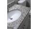 Close-up of the bathroom vanity with granite top and white cabinetry. Shows faucet and sink at 4111 Pine Heights Ne Dr, Atlanta, GA 30324