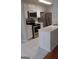 Well-equipped kitchen with stainless steel appliances, white cabinets, and tile flooring at 4111 Pine Heights Ne Dr, Atlanta, GA 30324